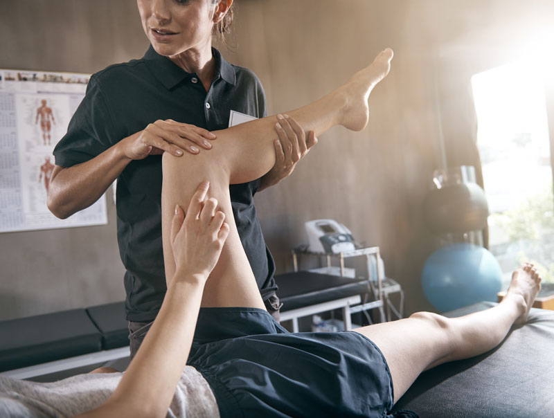 A therapist working with a patient on a table